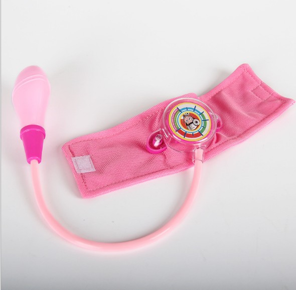 A child&#039;s imitation family doctor&#039;s toy takes blood pressure of a little doctor and nurse