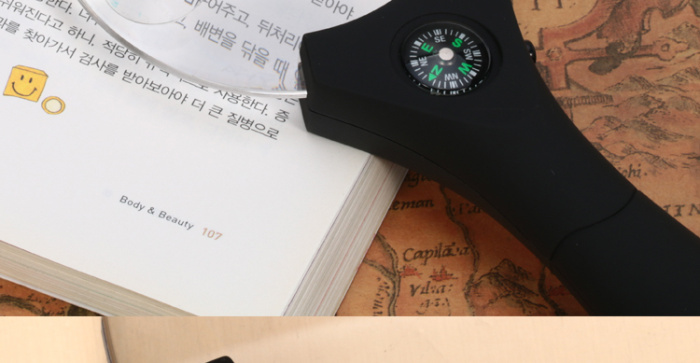 Hand-held magnifier with light diffuser with compass elderly elderly and children reading magnifier